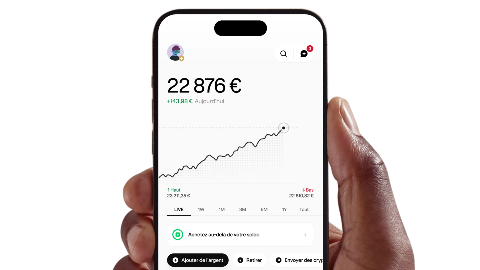 Hand holding a phone displaying the Kraken app portfolio and price chart
